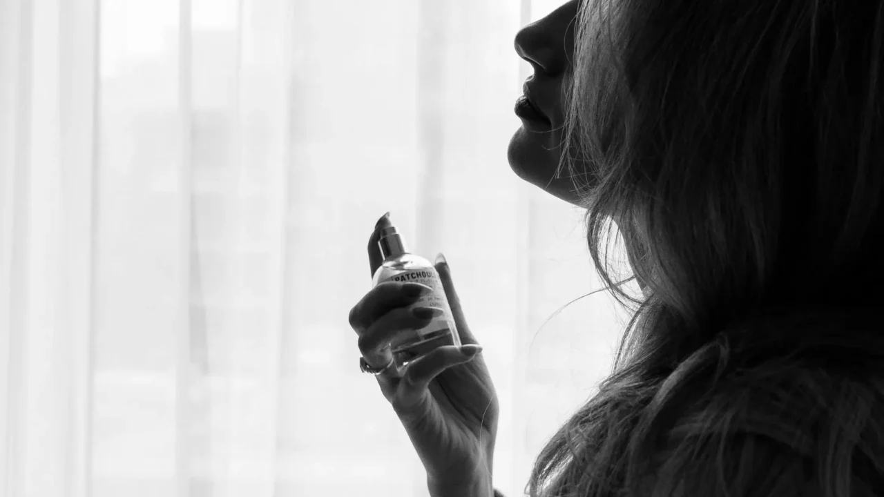 image of woman spraying fragrance