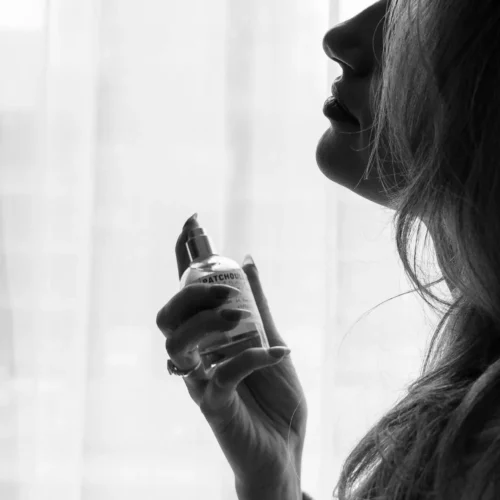 image of woman spraying fragrance