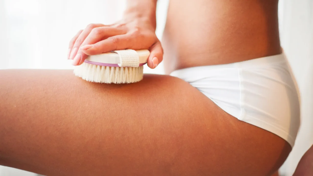 photo of woman dry brushing her leg