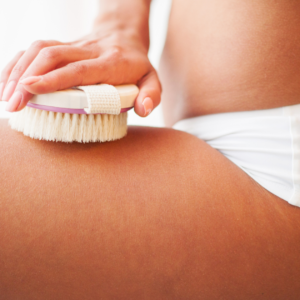 woman dry brushing leg