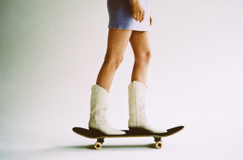 image of woman skateboarding with cowboy boots