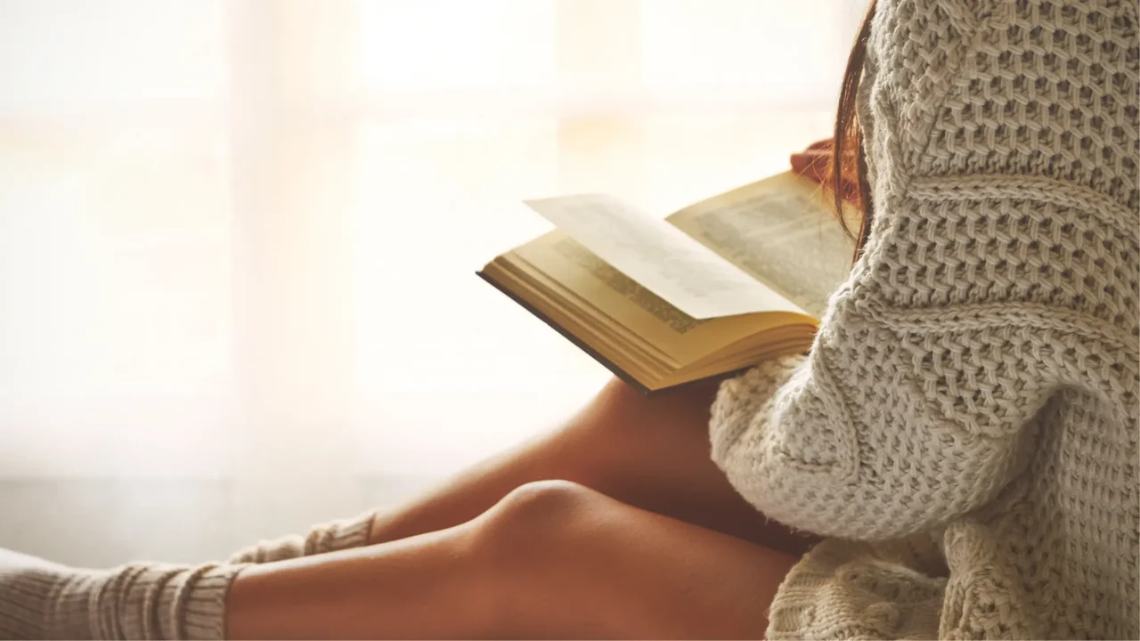 woman reading a self help book